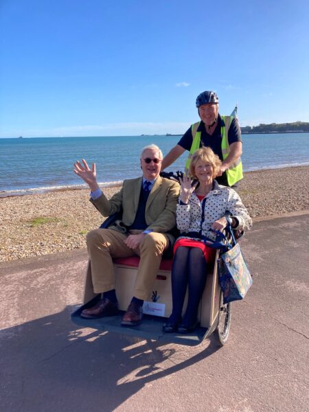 Mark Woodhouse and Judge Marilyn Barber enjoying a CYCALL trishaw ride around Weymouth
